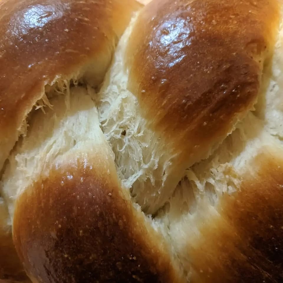 The braids of a loaf of challah bread.